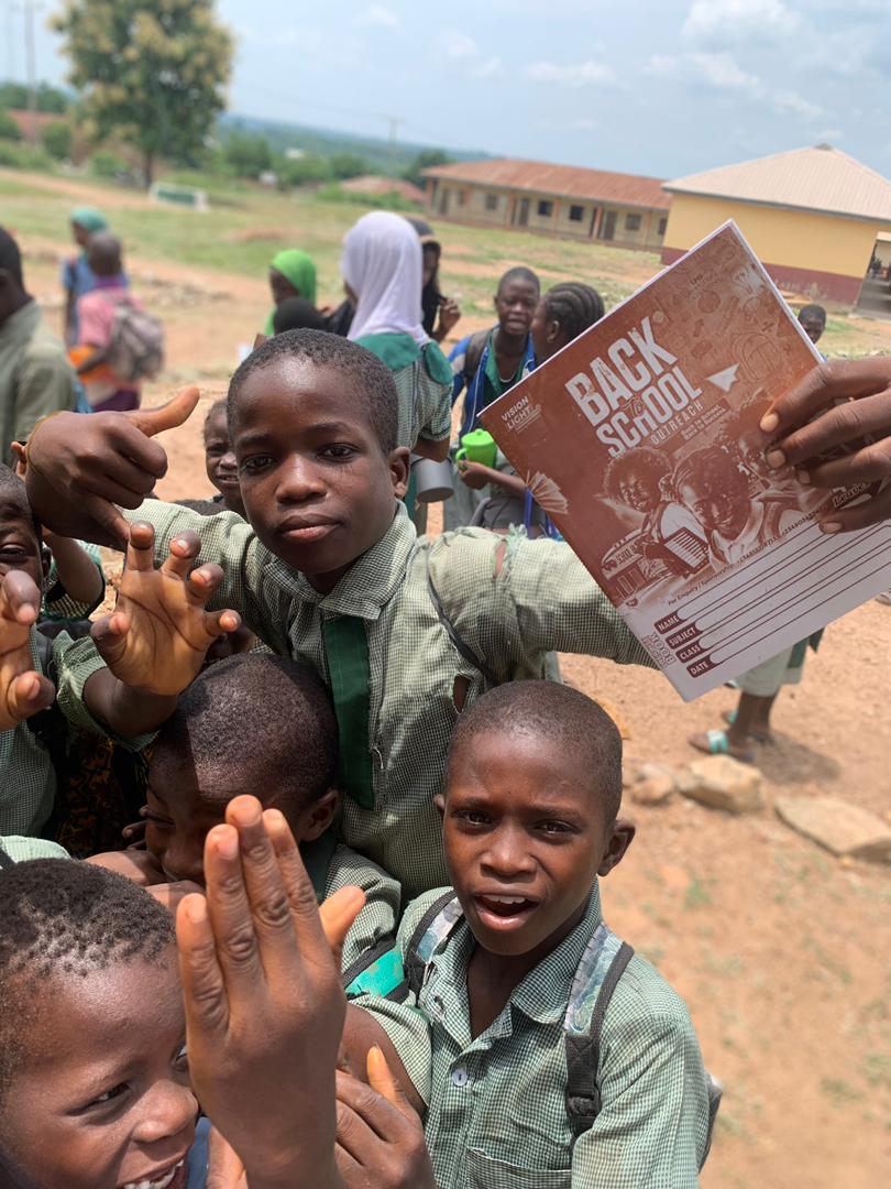 Pupils holding new exercise books